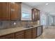 Kitchen featuring a stainless steel sink and granite countertops with wood cabinets at 4225 Telstar Ct, North Las Vegas, NV 89032