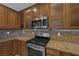 This kitchen offers stainless steel appliances, and stunning granite countertops and backsplash at 4225 Telstar Ct, North Las Vegas, NV 89032