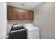 Laundry area with front loading washer and dryer plus storage cabinets above at 4225 Telstar Ct, North Las Vegas, NV 89032
