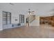 Expansive living room flows into a kitchen, featuring built-in shelves and neutral tile flooring at 4225 Telstar Ct, North Las Vegas, NV 89032