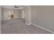 Spacious living room featuring neutral carpeting, arched doorways, and a ceiling fan for added comfort at 4225 Telstar Ct, North Las Vegas, NV 89032