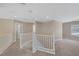 Upstairs loft space with neutral carpet, white railings, and recessed lighting at 4225 Telstar Ct, North Las Vegas, NV 89032