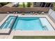 Refreshing swimming pool with blue tile and stone accents, perfect for relaxation and outdoor fun at 4225 Telstar Ct, North Las Vegas, NV 89032