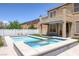 Stunning pool and spa with modern tile accents and a spacious deck, ideal for relaxation and entertainment at 4225 Telstar Ct, North Las Vegas, NV 89032
