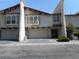 Charming townhome featuring a stucco exterior, a red tile roof, and attached garages at 5006 Schumann Dr, Las Vegas, NV 89146