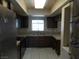 Compact kitchen featuring dark wood cabinetry and stainless steel appliances at 5006 Schumann Dr, Las Vegas, NV 89146