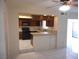 Functional kitchen features dark cabinetry and opens to the breakfast nook and living area at 5006 Schumann Dr, Las Vegas, NV 89146