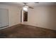 Living room with neutral walls, ceiling fan, carpet floors, and large window providing natural light at 5006 Schumann Dr, Las Vegas, NV 89146
