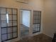 Living room featuring multiple windows for natural light, neutral paint, and entry into another room at 5006 Schumann Dr, Las Vegas, NV 89146