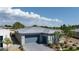 Aerial view of a modern home with a three-car garage and desert landscaping at 5095 E Long Leaf Ct, Pahrump, NV 89061
