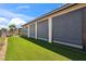 Well-maintained backyard with artificial grass and a covered patio area at 5095 E Long Leaf Ct, Pahrump, NV 89061