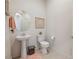 Contemporary half-bathroom featuring a pedestal sink and modern fixtures at 5095 E Long Leaf Ct, Pahrump, NV 89061