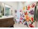 Well-lit bathroom with a floral shower curtain, modern fixtures, and ample space at 5095 E Long Leaf Ct, Pahrump, NV 89061
