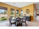 Bright dining area with a round table, six chairs, and views of the backyard at 5095 E Long Leaf Ct, Pahrump, NV 89061