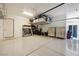 Organized garage with a storage loft and multiple storage cabinets at 5095 E Long Leaf Ct, Pahrump, NV 89061