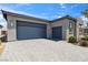 Spacious three-car garage with a paved driveway and well-maintained landscaping at 5095 E Long Leaf Ct, Pahrump, NV 89061