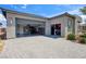 Spacious garage with an open door and well-organized storage and car lift at 5095 E Long Leaf Ct, Pahrump, NV 89061