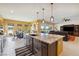 Open kitchen and dining area with modern appliances, an island, and comfortable seating at 5095 E Long Leaf Ct, Pahrump, NV 89061