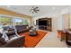 Open living room with a large TV, comfortable seating, and natural light at 5095 E Long Leaf Ct, Pahrump, NV 89061