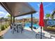 Outdoor patio with dining set and lounge chairs overlooking the pool and backyard at 5095 E Long Leaf Ct, Pahrump, NV 89061
