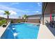Backyard pool featuring water feature, sunning deck, and tropical landscaping, ideal for relaxation at 5095 E Long Leaf Ct, Pahrump, NV 89061