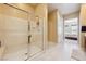Modern glass-enclosed shower in the bathroom, next to a bright hallway and bedroom entrance at 5095 E Long Leaf Ct, Pahrump, NV 89061