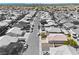 Aerial view of a home with a red tile roof nestled in a neighborhood with mature trees and desert landscaping at 5307 Wild Orchid St, North Las Vegas, NV 89031