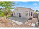 Landscaped backyard features patio, desert rock, and privacy wall at 5307 Wild Orchid St, North Las Vegas, NV 89031