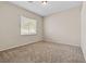 Bedroom with neutral carpet and walls, and a window that provides natural light at 5307 Wild Orchid St, North Las Vegas, NV 89031