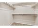 Walk-in closet with carpeted flooring and white shelving and rods for organization at 5307 Wild Orchid St, North Las Vegas, NV 89031