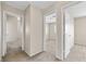 Hallway featuring multiple doorways into bedrooms or bathrooms and neutral colored walls at 5307 Wild Orchid St, North Las Vegas, NV 89031