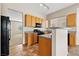 Bright kitchen featuring tile floors, wooden cabinets, granite counters, and modern appliances at 5307 Wild Orchid St, North Las Vegas, NV 89031
