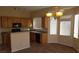 Functional kitchen with sleek appliances, wooden cabinetry and a breakfast bar at 5307 Wild Orchid St, North Las Vegas, NV 89031