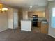 Well-equipped kitchen with an island, granite countertops, and stainless steel appliances at 5307 Wild Orchid St, North Las Vegas, NV 89031