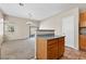 Kitchen featuring granite countertops, wood cabinets, and seamless flow to the living area at 5307 Wild Orchid St, North Las Vegas, NV 89031