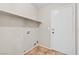Functional laundry area with connections, shelving, and tile flooring at 5307 Wild Orchid St, North Las Vegas, NV 89031