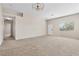 Inviting living room with neutral carpet, a large window, and easy access to other areas at 5307 Wild Orchid St, North Las Vegas, NV 89031