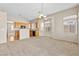 Open-concept kitchen and living area with a breakfast bar and large windows for natural light at 5307 Wild Orchid St, North Las Vegas, NV 89031