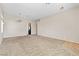 Bright, open-plan living room featuring neutral carpet and a view of the kitchen area at 5307 Wild Orchid St, North Las Vegas, NV 89031