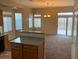 Open-concept living space filled with natural light, carpet, and a sliding door to backyard at 5307 Wild Orchid St, North Las Vegas, NV 89031
