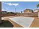 Large concrete patio surrounded by desert landscaping and block wall fence at 5835 Running Horse Dr, North Las Vegas, NV 89081