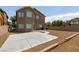 Large backyard featuring desert landscaping, a concrete patio, and two-story home at 5835 Running Horse Dr, North Las Vegas, NV 89081