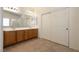Bright bathroom featuring a double vanity, large mirror, and sliding door closet at 5835 Running Horse Dr, North Las Vegas, NV 89081