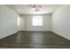 Bright bedroom featuring wood-look floors, modern ceiling fan, and natural light at 5835 Running Horse Dr, North Las Vegas, NV 89081