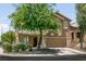 Charming two-story home featuring a well-maintained lawn and an attached two-car garage at 5835 Running Horse Dr, North Las Vegas, NV 89081