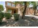 Charming two-story house with desert landscaping and an attached two-car garage at 5835 Running Horse Dr, North Las Vegas, NV 89081