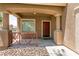 Inviting front porch with a red door and decorative metal railing at 5835 Running Horse Dr, North Las Vegas, NV 89081