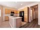 Bright kitchen features wood cabinets, a center island with a double sink, and black appliances at 5835 Running Horse Dr, North Las Vegas, NV 89081