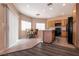 Eat-in kitchen featuring tile flooring, wooden cabinets, and black appliances at 5835 Running Horse Dr, North Las Vegas, NV 89081