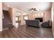Cozy living room with wood floors, comfortable seating, open layout, and staircase to the upper level at 5835 Running Horse Dr, North Las Vegas, NV 89081
